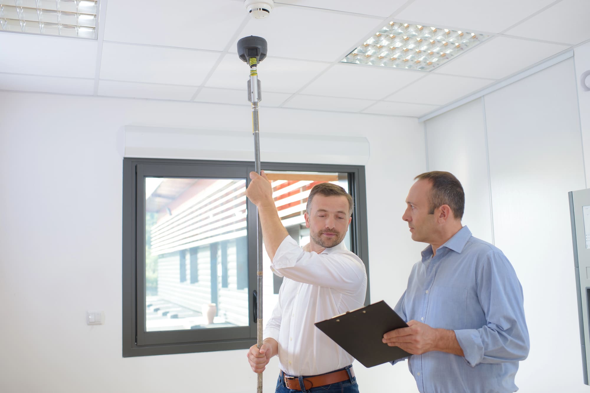 Fire code compliance services Cleveland expert testing sprinkler system during facility inspection