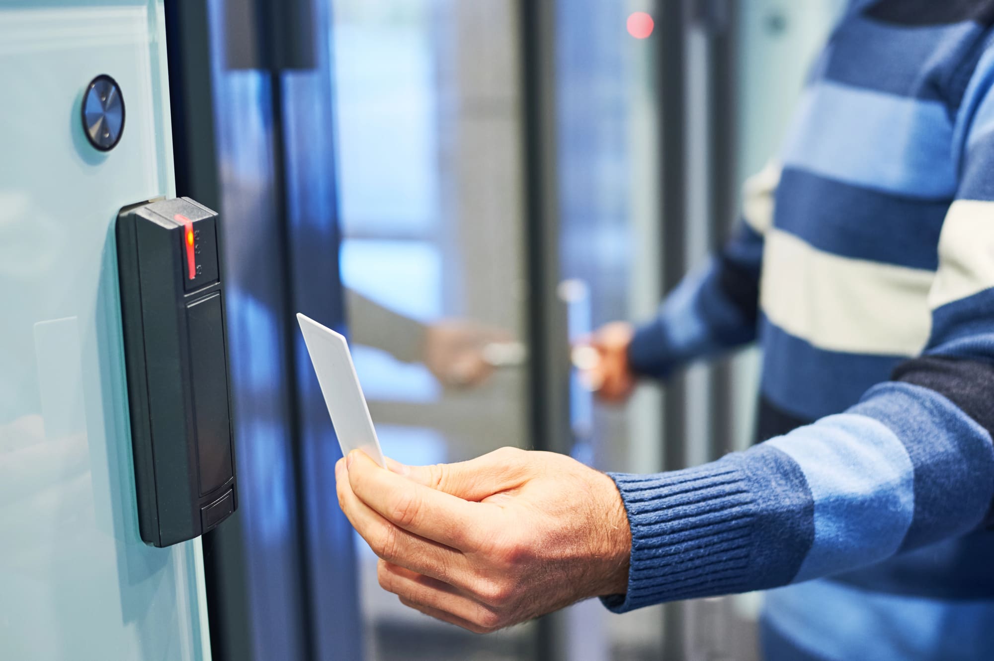 Access Control Systems for Euclid Businesses: employee taps keycard to enter secured office